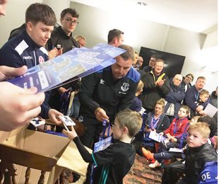 Everton coaches signing posters for children in the Vauxhall Sports Club