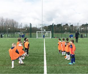 Children training and learning how to play football at Vauxhall Sports Club