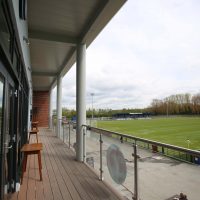 Behind the Vauxhall Motors Sports Club showing the balcony and football fields in the background